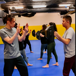 Students practicing self-defense techniques on each other